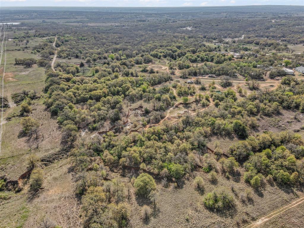 5 County Road 3855 Poolville, TX 76487 - Photo 3 of 16 an aerial view of residential houses with outdoor space