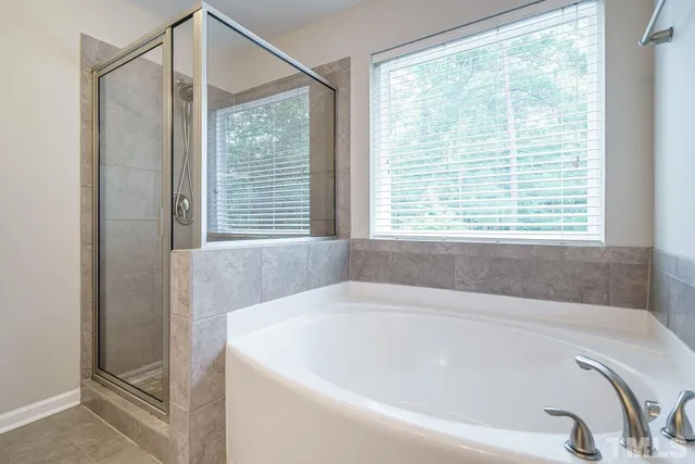 a bathroom with a bathtub and a shower