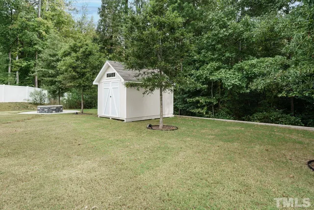 a backyard of a house with trees and entertaining space