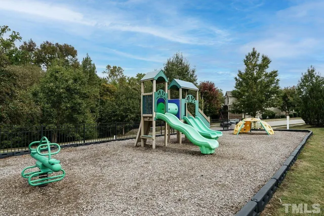 a view of outdoor space with playground and green space