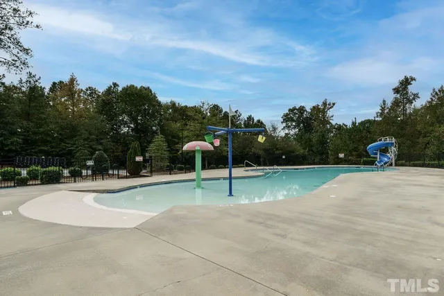 a view of a swimming pool with a yard