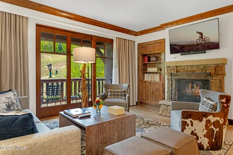 a living room with furniture and a floor to ceiling window