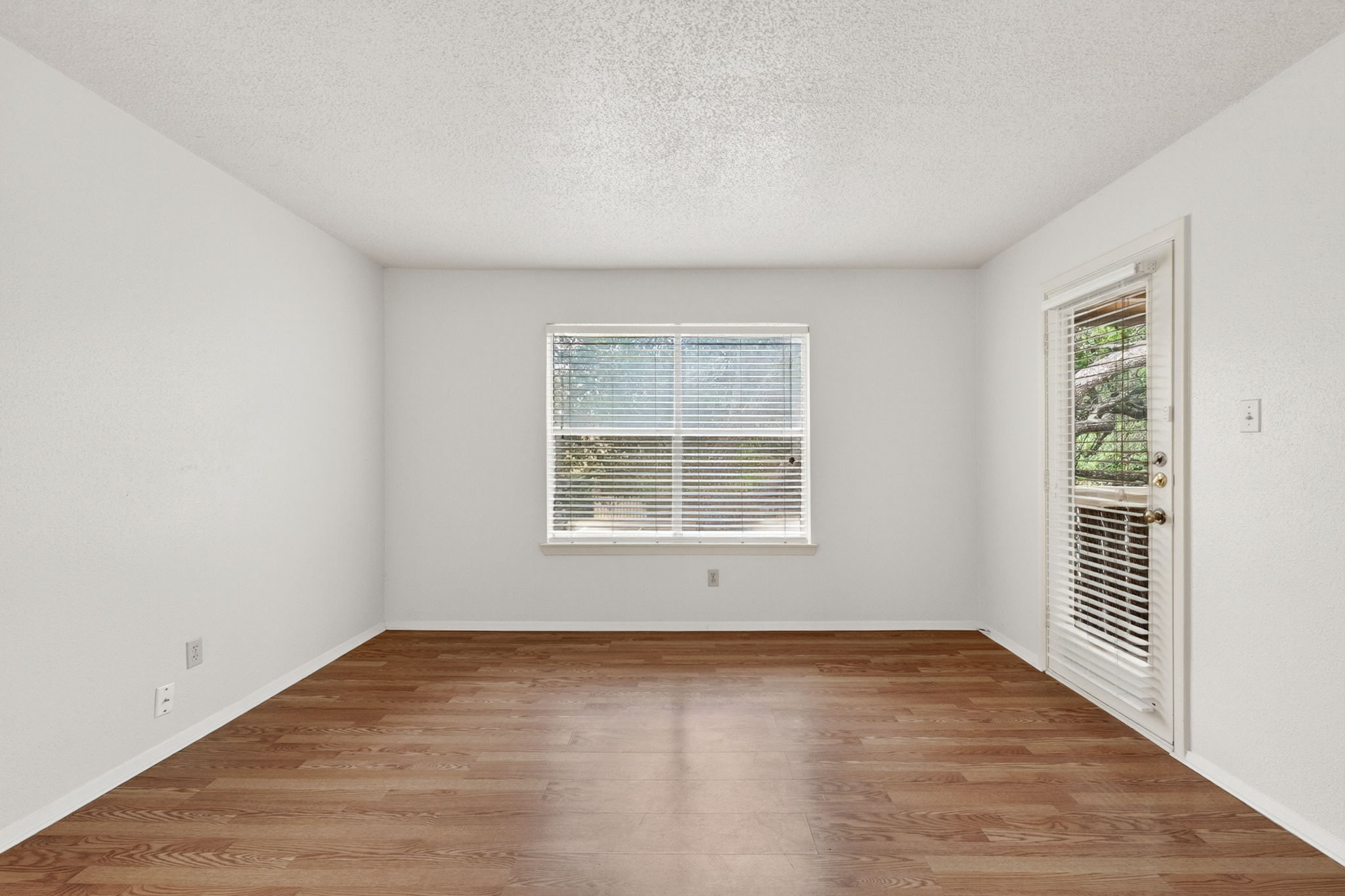 8210 Bent Tree Road, Unit 256 Austin, TX 78759 - Photo 6 of 29 an empty room with wooden floor and windows