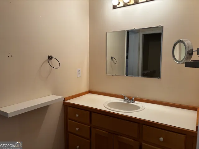 a bathroom with a sink and a mirror