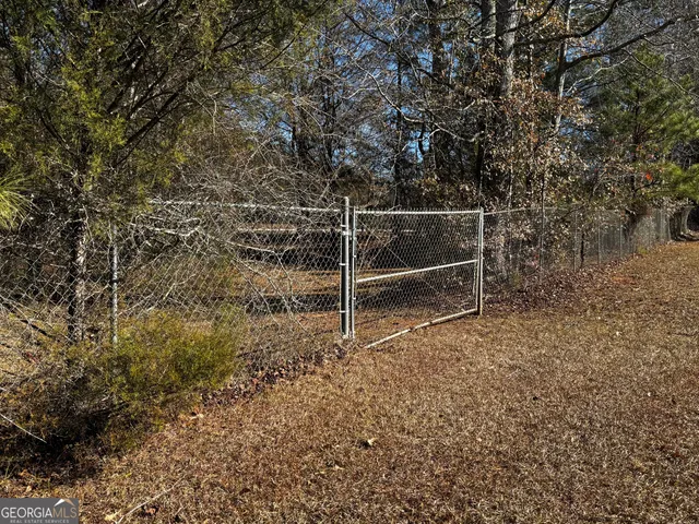 a view of an empty room with wooden fence
