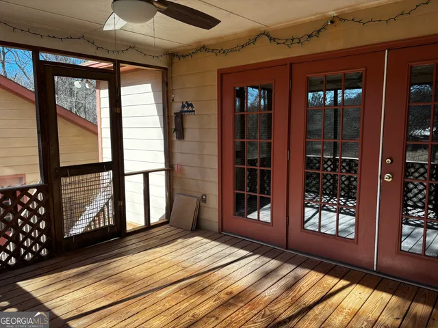 a view of a balcony with wooden floor and iron stairs