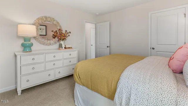 a bedroom with a bed and a dresser in it