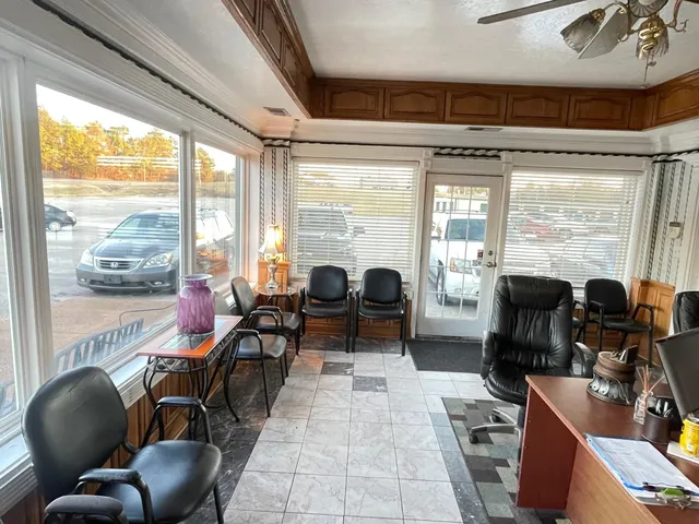 a view of a livingroom with workspace and a window