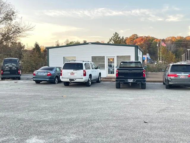 a couple of cars parked in front of a house