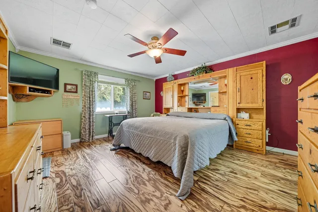 a spacious bedroom with a bed and a chandelier