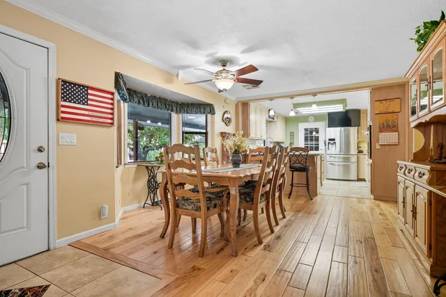 a view of a dining room with furniture and wooden floor