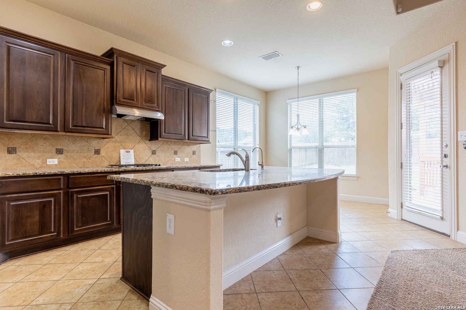 8103 Mystic Chase Boerne, TX 78015 - Photo 18 of 49 a kitchen with granite countertop a sink cabinets and stainless steel appliances