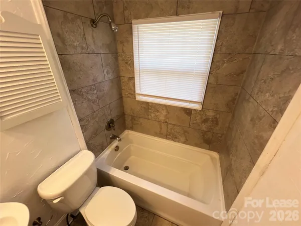 a bathroom with a toilet and a bathtub