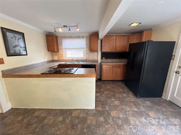 a kitchen with a refrigerator sink and cabinets