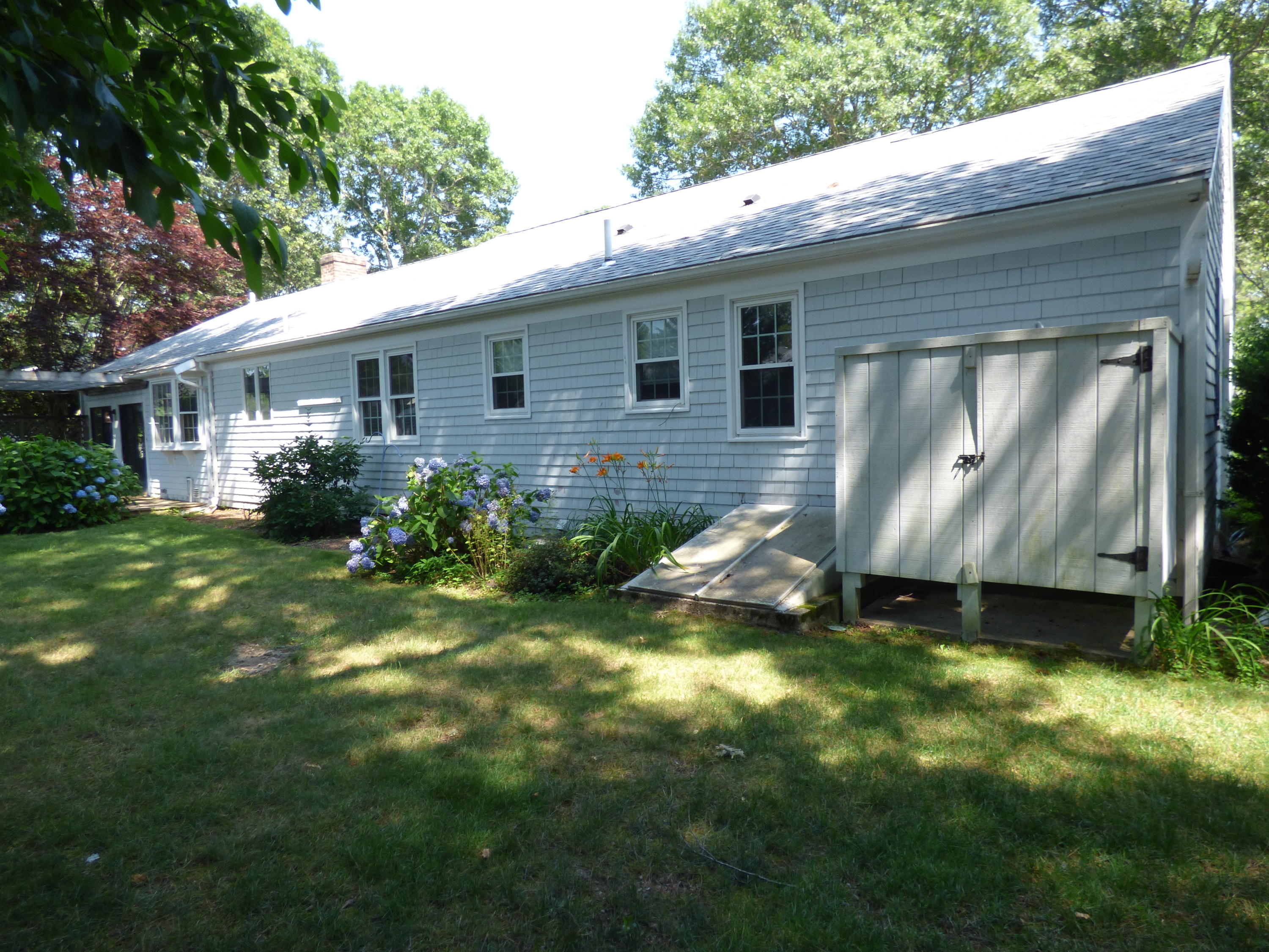 195 Ansel Howland Road Centerville, MA 02632 - Photo 15 of 22 a view of a house with a yard and plants