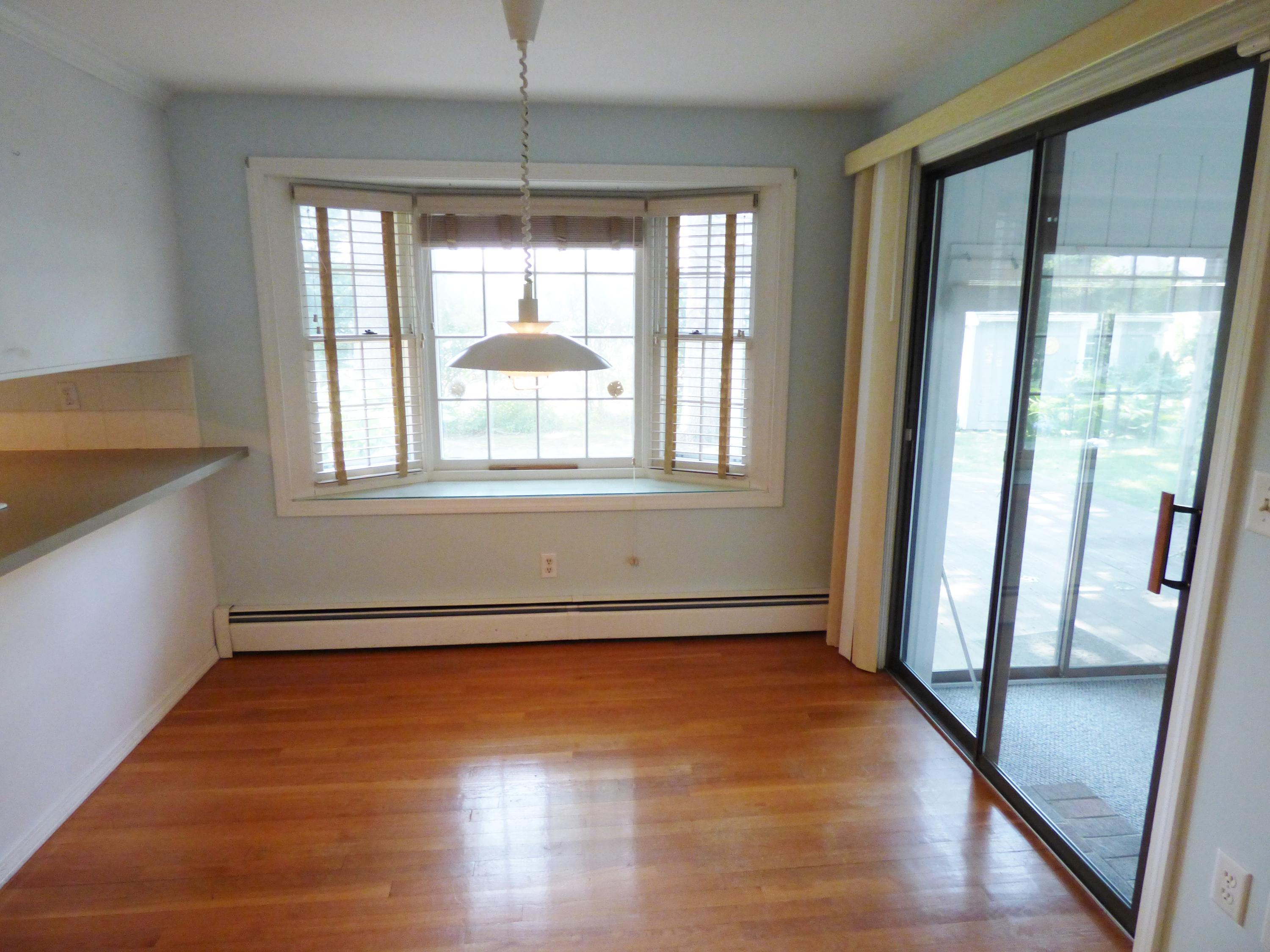 195 Ansel Howland Road Centerville, MA 02632 - Photo 6 of 22 a view of an empty room with wooden floor and a window