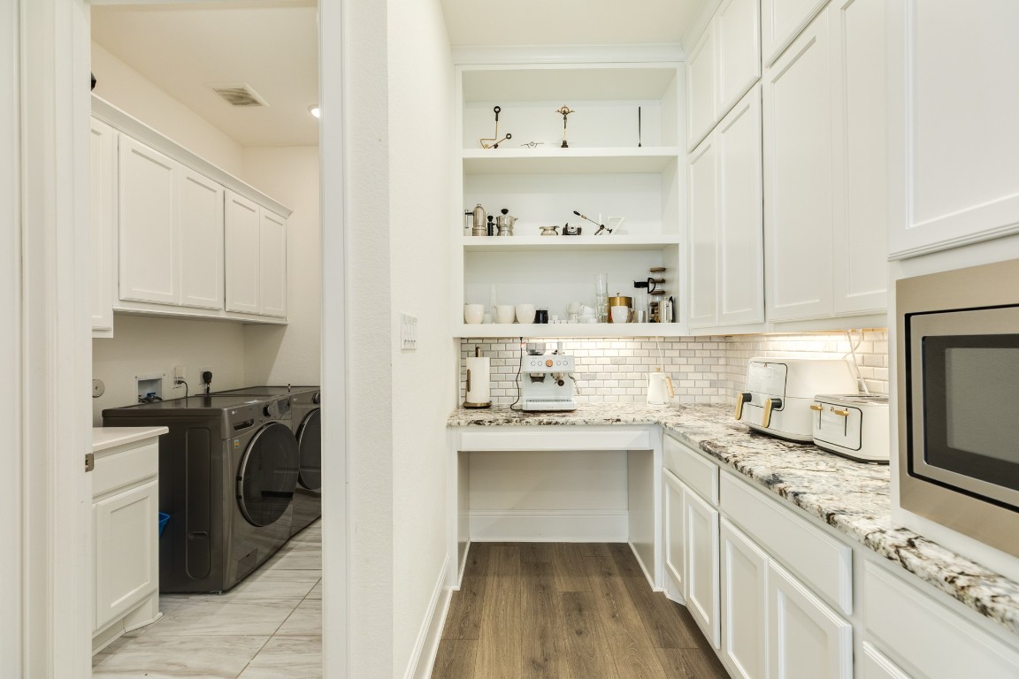10102 Brush Way Rosharon, TX 77583 - Photo 18 of 50 Off the kitchen is the laundry room, garage access, and walk-in pantry. This description provides a clear and concise overview of the spaces directly connected to the kitchen.
