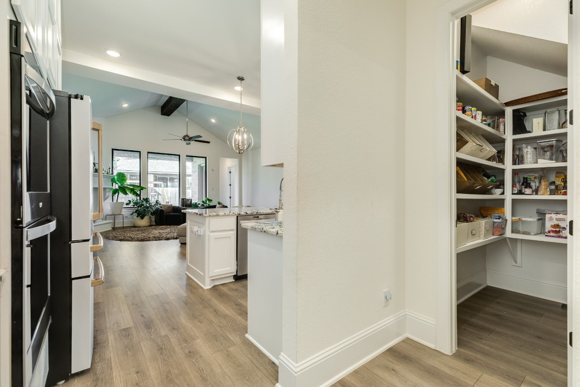 10102 Brush Way Rosharon, TX 77583 - Photo 19 of 50 This view showcases the walk-in pantry, highlighting the seamless transition to the kitchen and family area.