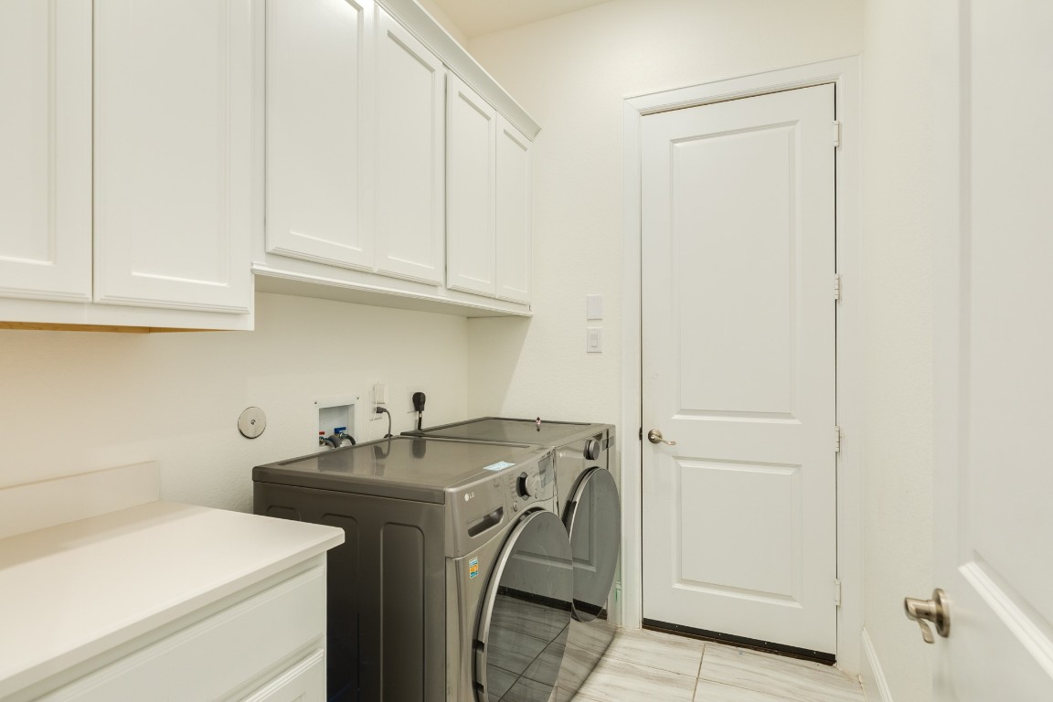 10102 Brush Way Rosharon, TX 77583 - Photo 20 of 50 Spacious laundry room boasting ample storage, a convenient folding counter, and direct access to the three-car garage.