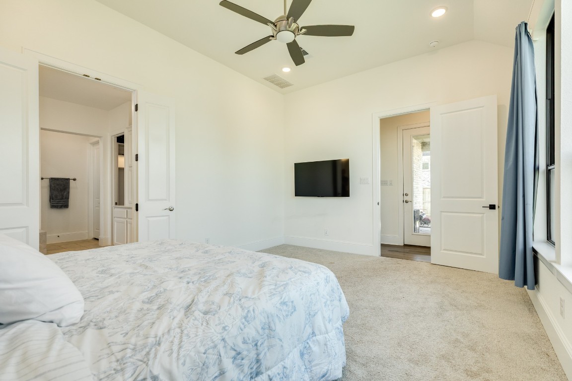 10102 Brush Way Rosharon, TX 77583 - Photo 22 of 50 This view showcases the entrance to the primary suite and the back door that provides access to the covered patio. To the left are double doors that lead into the primary bathroom.