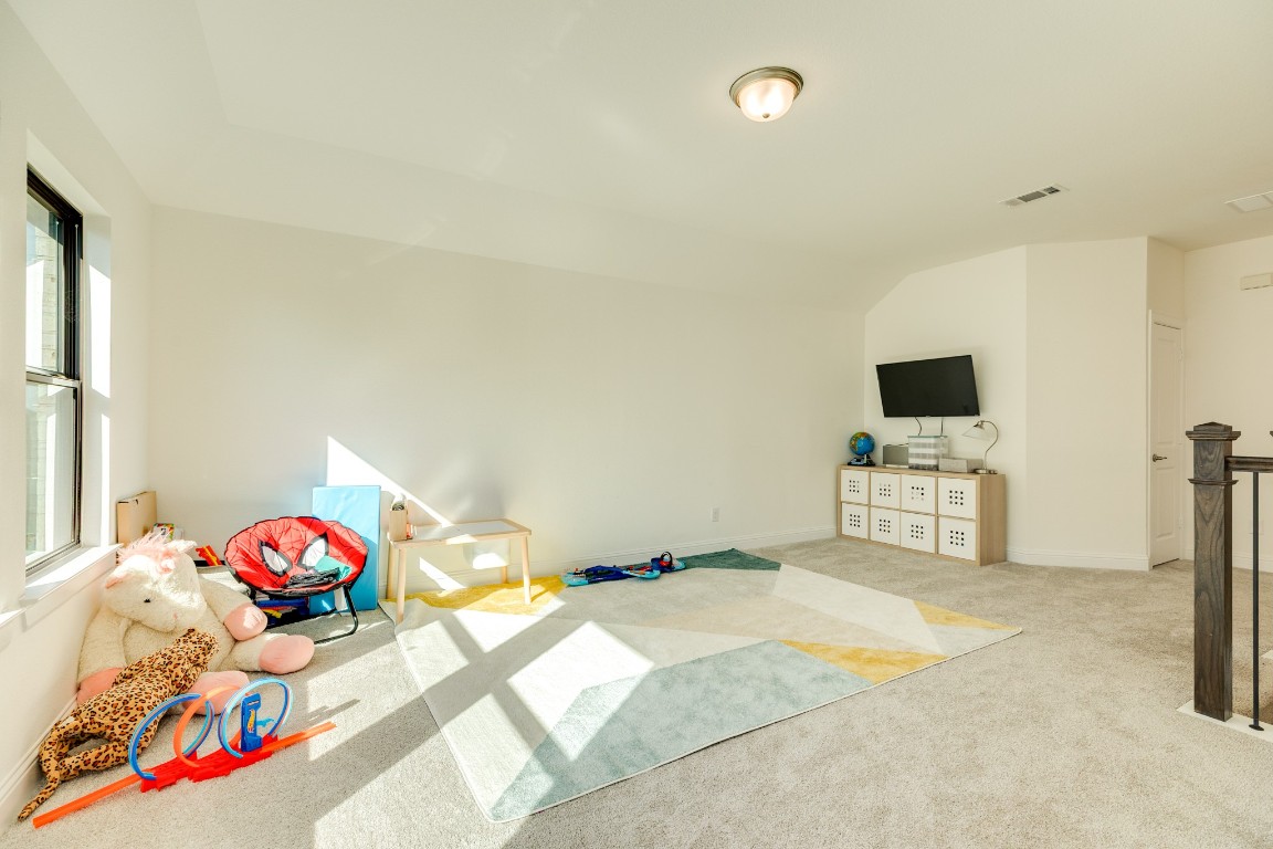 10102 Brush Way Rosharon, TX 77583 - Photo 29 of 50 Alternative perspective of the game room/play area, showcasing its potential as a comfortable sitting area for teenagers and their friends.