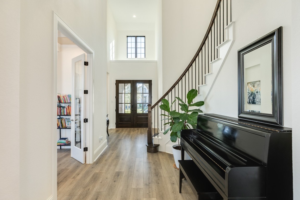 10102 Brush Way Rosharon, TX 77583 - Photo 4 of 50 Upon entering, you are greeted by a stunning spiral staircase, and to the right, a dedicated office with double glass doors, ideal for those who work from home.