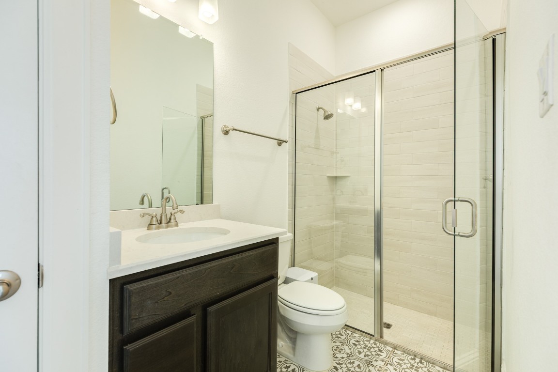10102 Brush Way Rosharon, TX 77583 - Photo 7 of 50 Guest suite bathroom featuring a glass walk-in shower and decorative flooring.