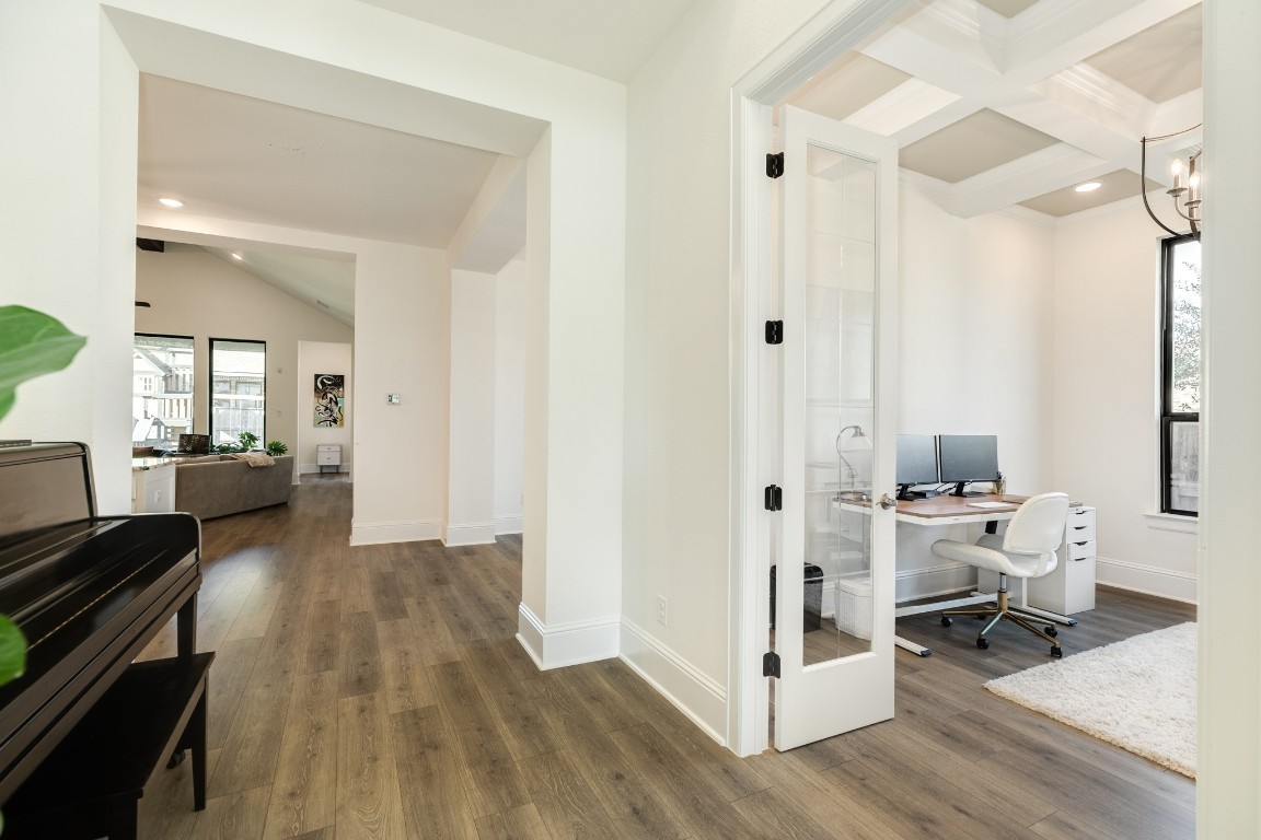 10102 Brush Way Rosharon, TX 77583 - Photo 8 of 50 Spacious hallway and to the right is a dedicated office with beautiful wood flooring, a trey decorative ceiling, lots of natural light, and recessed lighting. Perfect for working from home.
