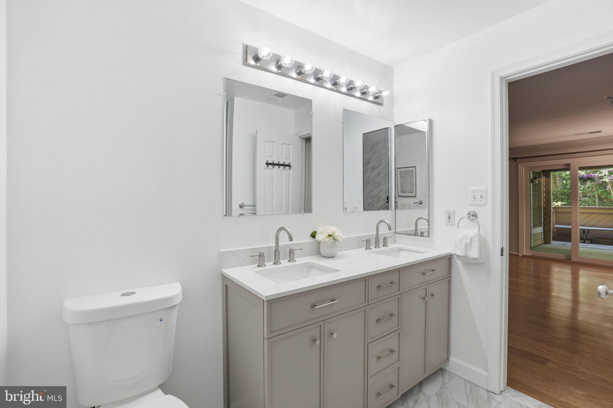 1495 Church Hill Place Reston, VA 20194 - Photo 18 of 27 a bathroom with a double vanity sink mirror and toilet