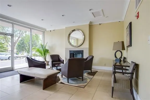 a living room with furniture a fireplace and a large window