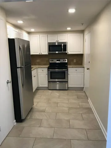 a kitchen with a refrigerator and a sink