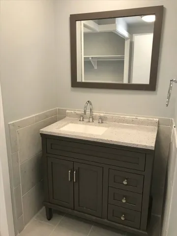 a bathroom with a sink vanity and mirror