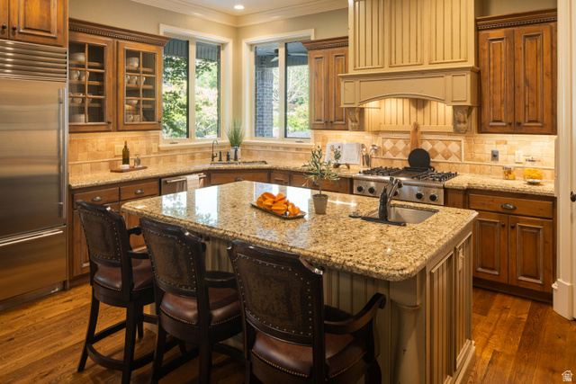 875 South 1250th Street East Mapleton, UT 84664 - Photo 23 of 54 Spacious kitchen featuring a central island with a built-in sink, stainless steel appliances, wood-finish flooring, ample cabinetry, and granite countertops