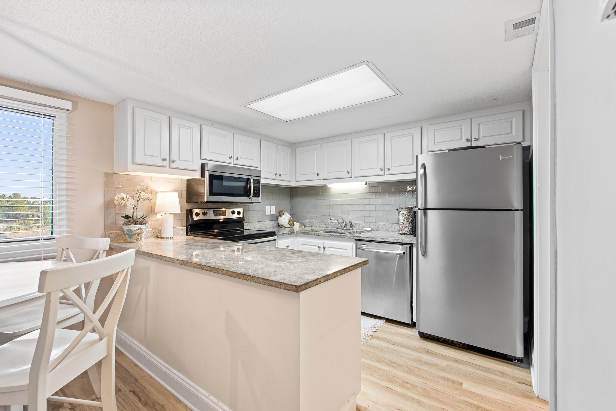 23223 Front Beach Road, Unit 113 Panama City Beach, FL 32413 - Photo 18 of 67 a kitchen with stainless steel appliances granite countertop a refrigerator stove a sink and dishwasher