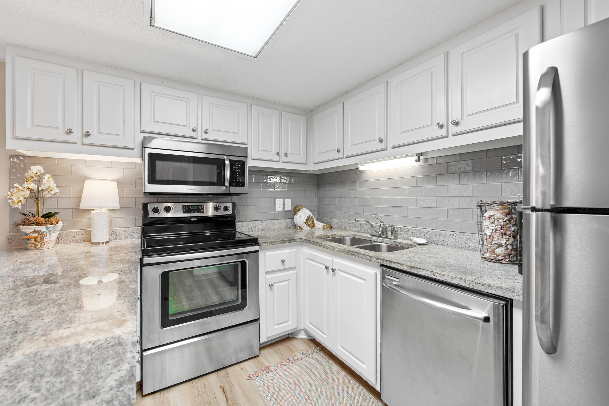 23223 Front Beach Road, Unit 113 Panama City Beach, FL 32413 - Photo 20 of 67 a kitchen with stainless steel appliances granite countertop a sink stove and refrigerator