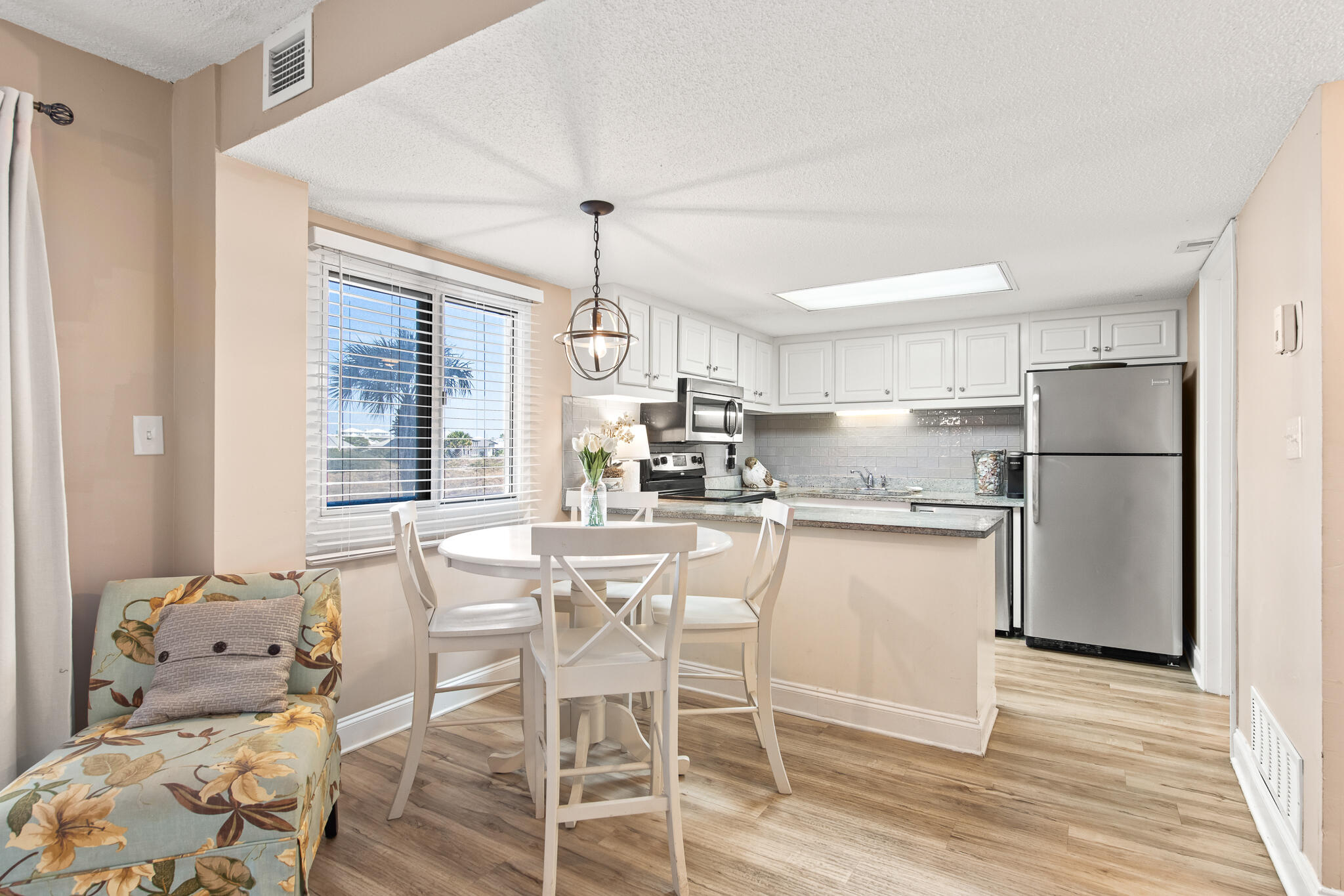 23223 Front Beach Road, Unit 113 Panama City Beach, FL 32413 - Photo 21 of 67 a kitchen with refrigerator and cabinets