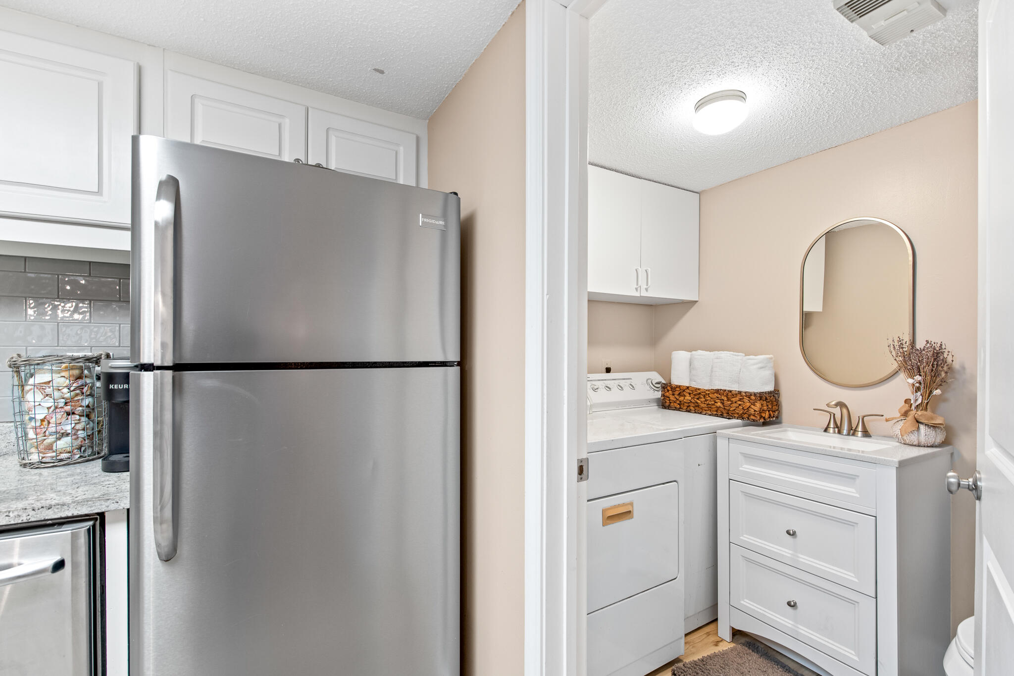 23223 Front Beach Road, Unit 113 Panama City Beach, FL 32413 - Photo 24 of 67 a kitchen with stainless steel appliances a refrigerator sink and cabinets