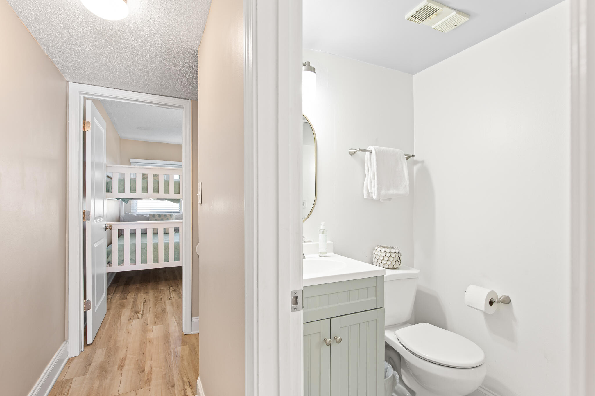 23223 Front Beach Road, Unit 113 Panama City Beach, FL 32413 - Photo 26 of 67 a bathroom with a toilet a sink and a mirror