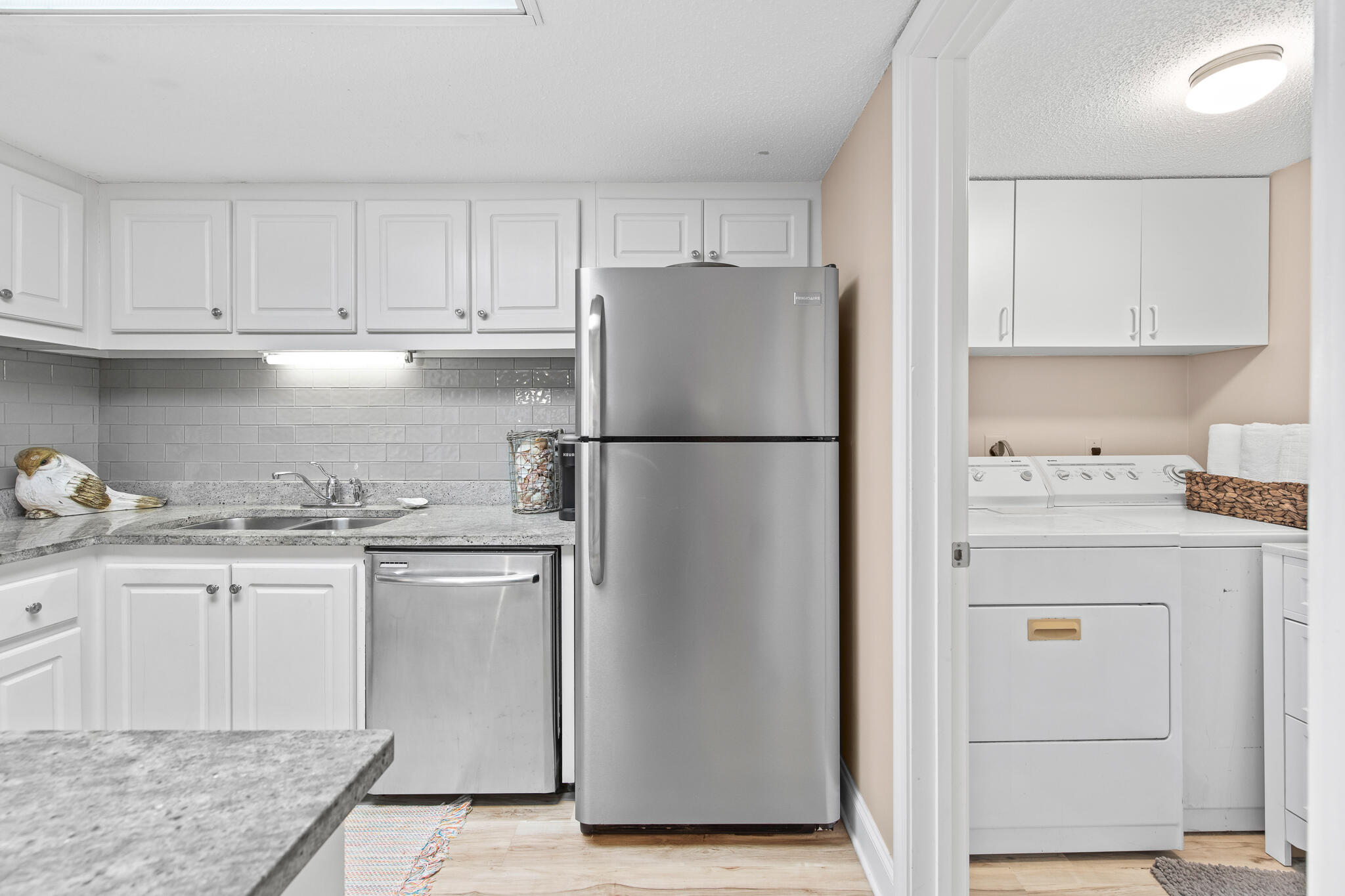 23223 Front Beach Road, Unit 113 Panama City Beach, FL 32413 - Photo 27 of 67 a kitchen with stainless steel appliances granite countertop a refrigerator sink and cabinets