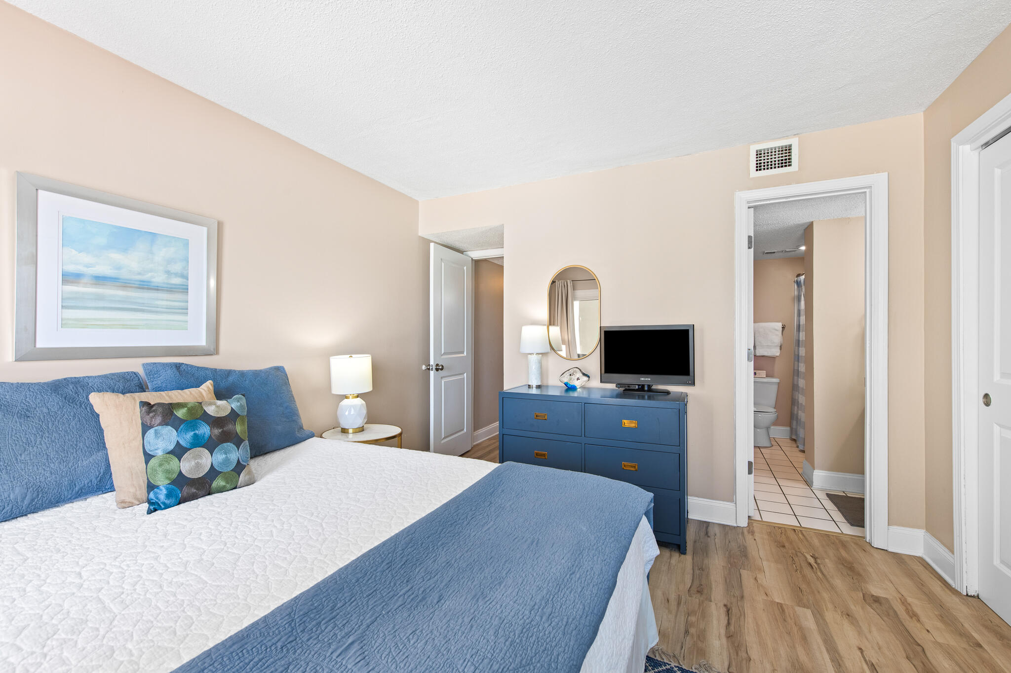 23223 Front Beach Road, Unit 113 Panama City Beach, FL 32413 - Photo 29 of 67 a bedroom with a bed and a flat screen tv