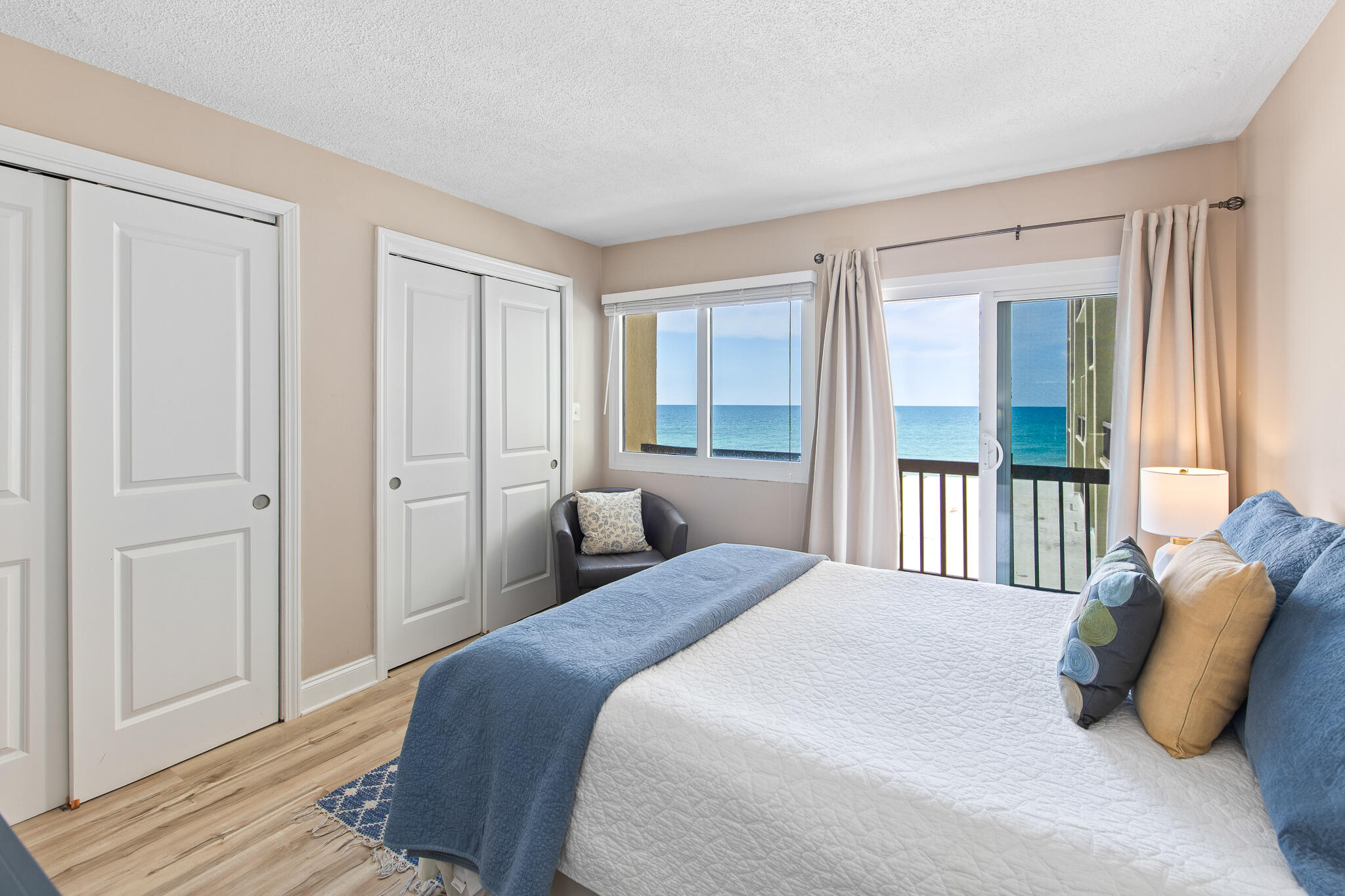 23223 Front Beach Road, Unit 113 Panama City Beach, FL 32413 - Photo 3 of 67 a bedroom with a bed and wooden floor