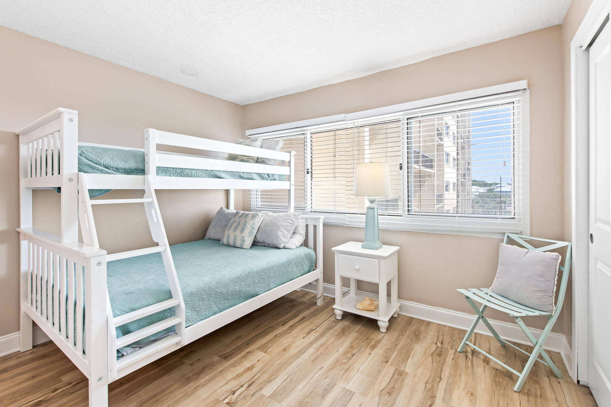 23223 Front Beach Road, Unit 113 Panama City Beach, FL 32413 - Photo 38 of 67 a bedroom with a bed and a view of chair