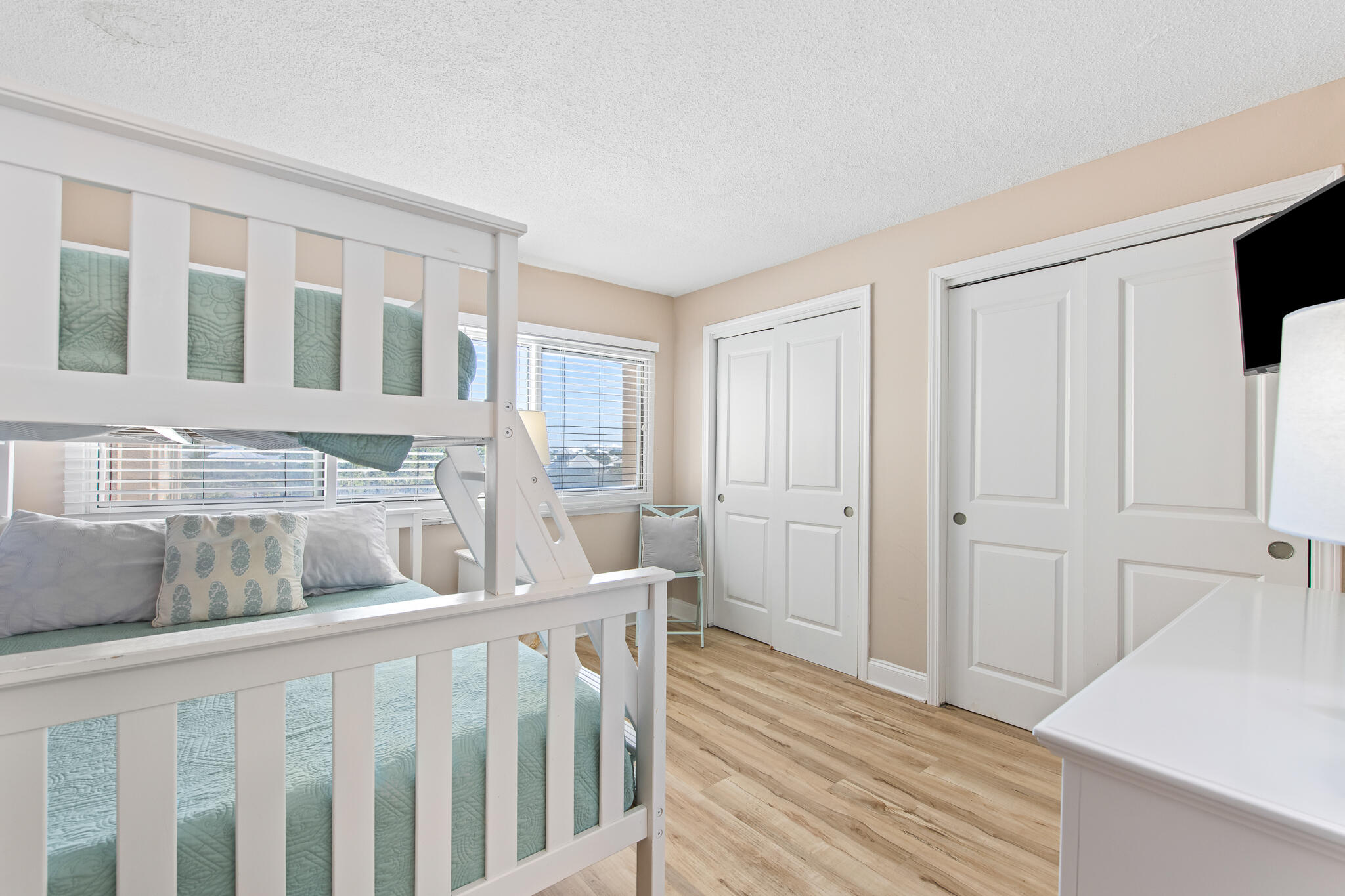 23223 Front Beach Road, Unit 113 Panama City Beach, FL 32413 - Photo 39 of 67 a bedroom with furniture and wooden floor