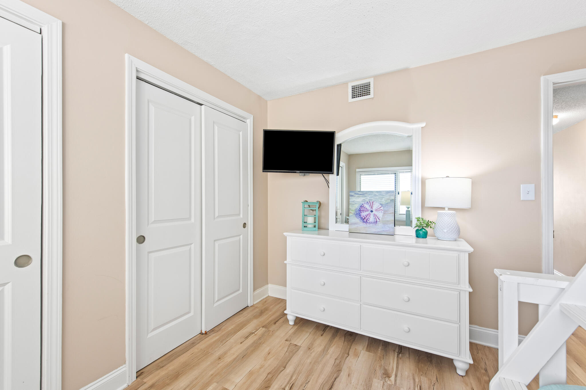 23223 Front Beach Road, Unit 113 Panama City Beach, FL 32413 - Photo 42 of 67 a bedroom with a bed and a flat tv screen in it