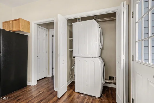 a view of walk in closet with wooden floor and stairs