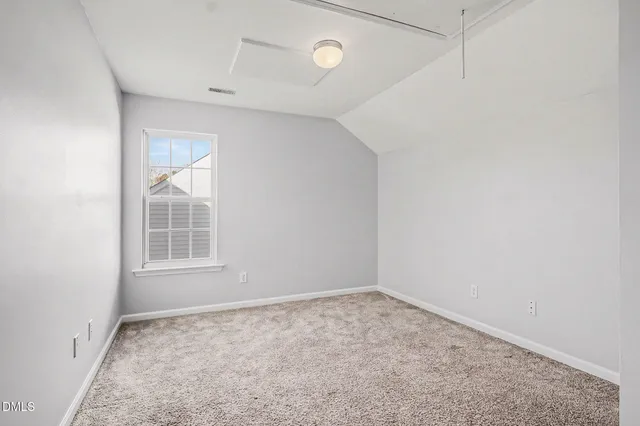an empty room with a empty space and windows