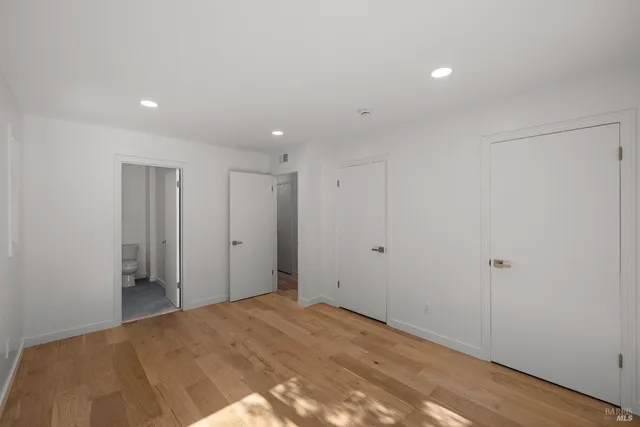 a view of hallway with wooden floor