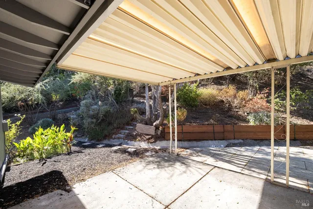 a view of a patio with table and chairs and potted plants