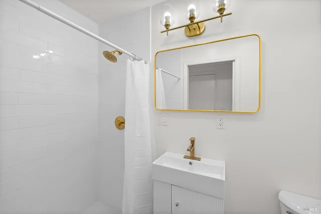 a bathroom with a sink a mirror and vanity