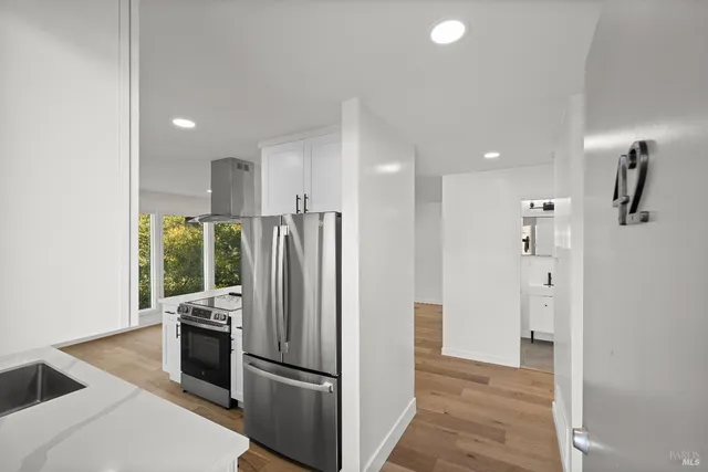 a kitchen with a refrigerator and a sink